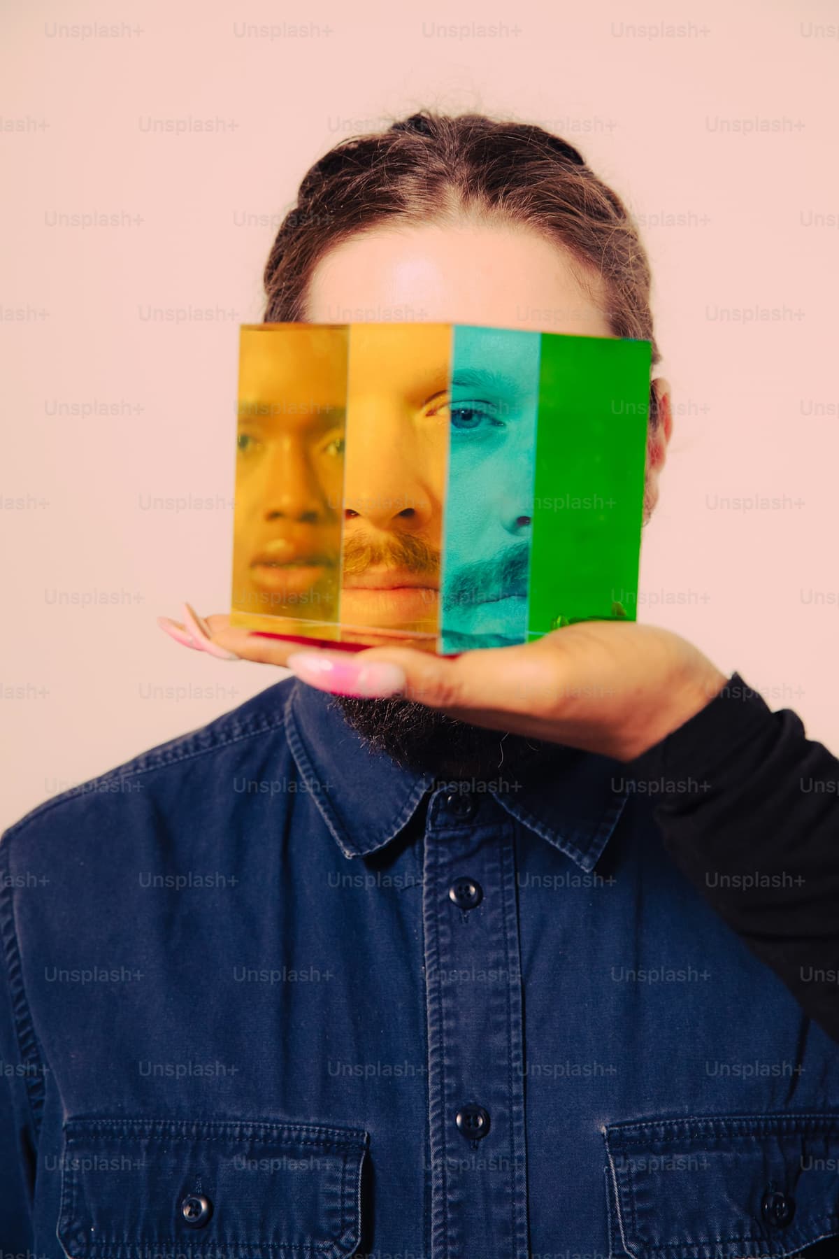 Person with colorful rectangular overlays on their face representing identity manipulation