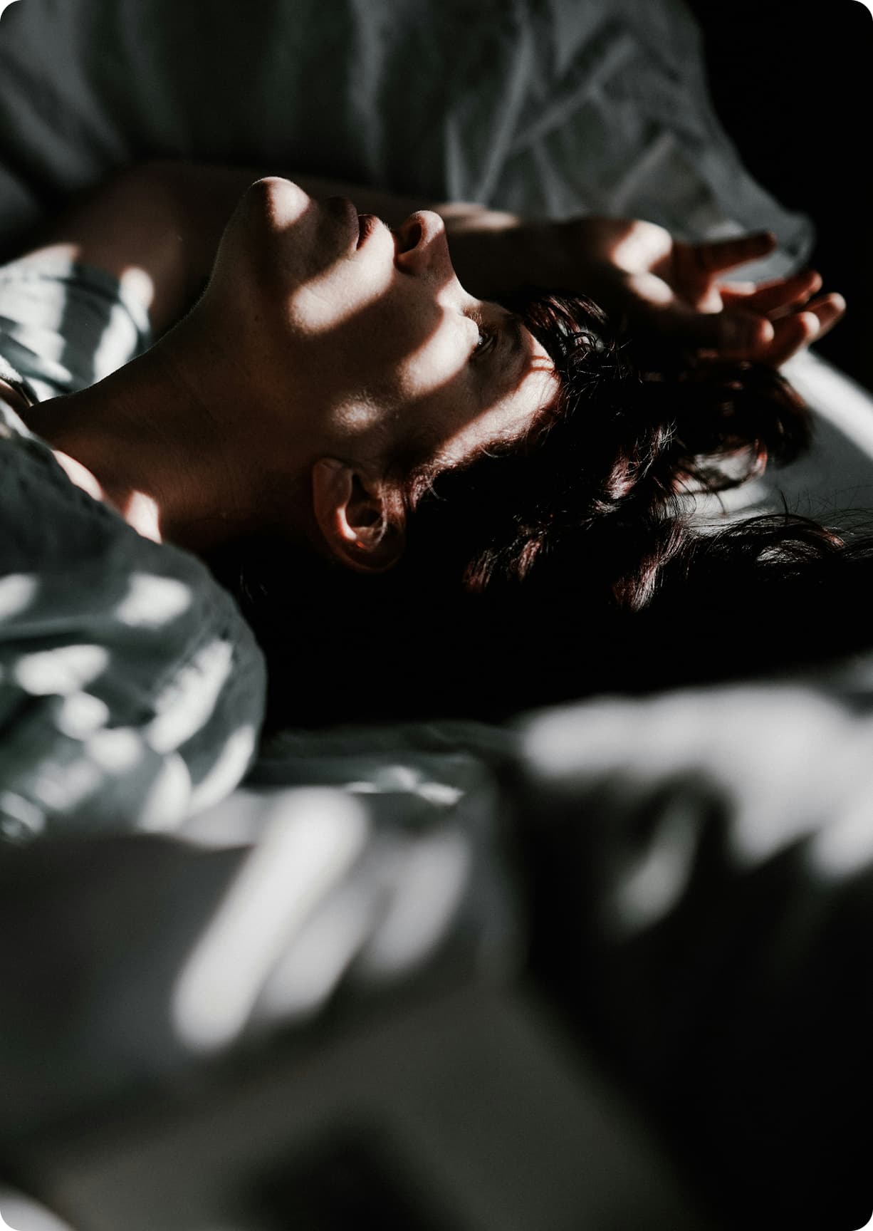 A person sitting alone, representing the isolation survivors of image-based sexual abuse often feel when they are blamed